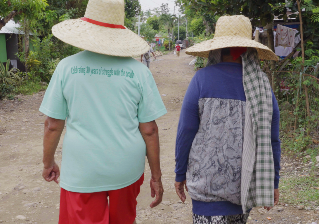 Enzo Camacho and Ami Lien, Langit Lupa (Heaven and Earth), 2023. Film still. Courtesy of the artists. A still from a film by Enzo Camacho and Ami Lien. There are a small group of children running through lush green plants, presumable sugar cane plants.